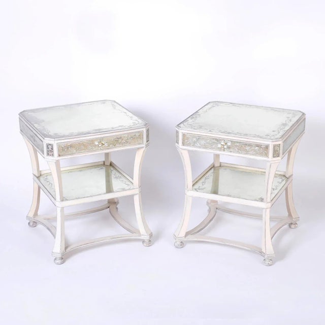 Pair of Italian two-tiered nightstands or end tables featuring reverse painted panels decorated with lovely floral designs...