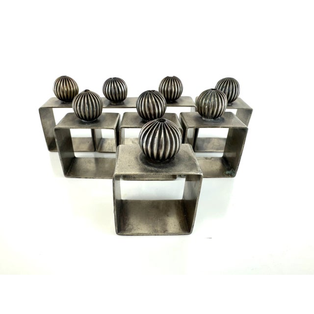 Striking and sculptural, this vintage Brutalist napkin ring set brings a bold presence to the dining table. The set...