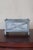 A small rectangular planter with X-cross banding on each long side, four ball finials at the top corners, and scrolled...