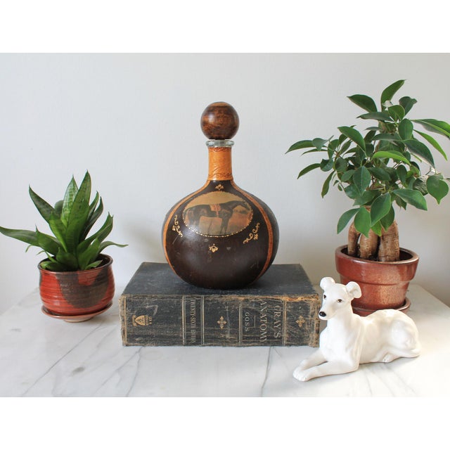 1960's vintage Fausto Corduri leather wrapped liquor or wine decanter. It features a bulbous round body covered in dark...
