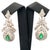 Luxurious 14K rose and white gold drop earrings featuring 2 emeralds totaling 1.50 carats, accented by 56 natural diamonds...