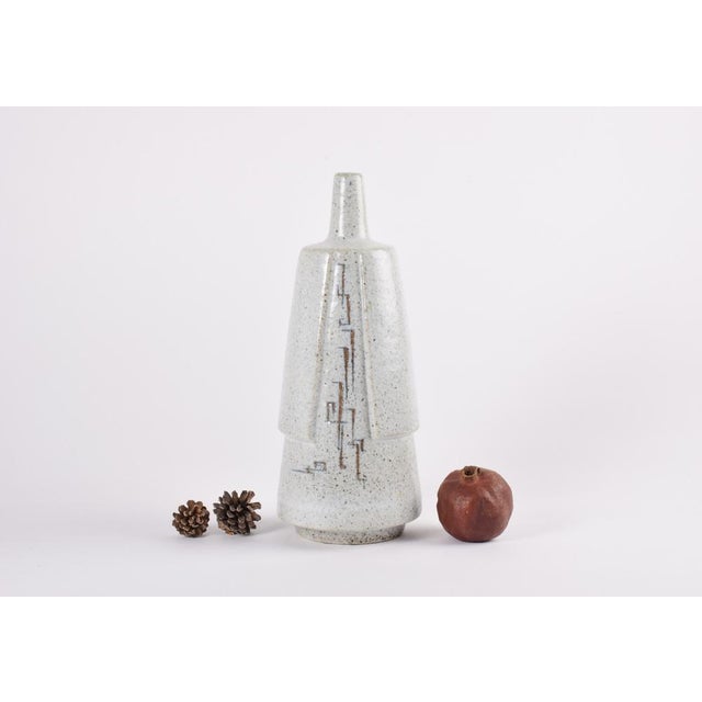 Unique tall stoneware vase by ceramist Melike Abasiyanik for Royal Copenhagen. Made 1960s. The flask shaped vase has a...