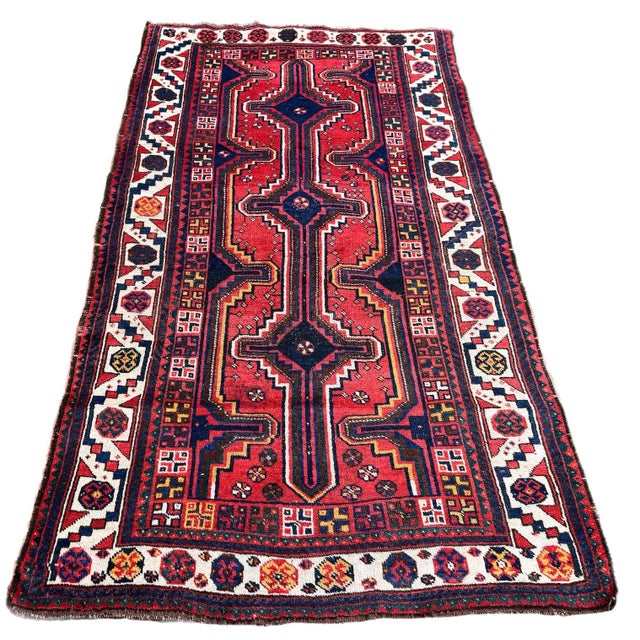 A lovely antique tribal rug, woven by the nomadic Lors circa 1920. The rug features a geometrical design on a rich...