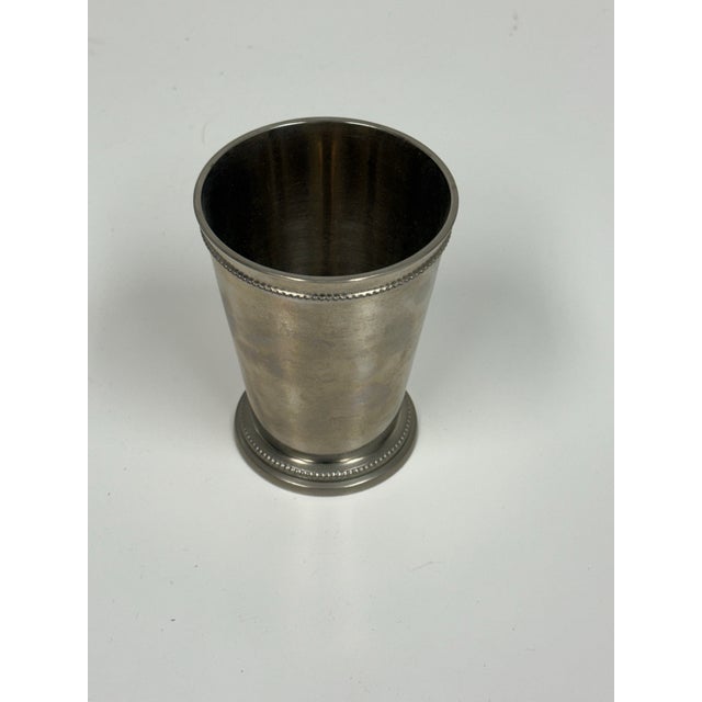 Design Plus Gallery presents an Antique Silver-plate Vase. The surface of the vase displays a soft, aged patina with...