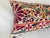 Elegant decorative pillow upholstered in a richly patterned Uzbek textile, featuring charming floral flowerhead motifs and...