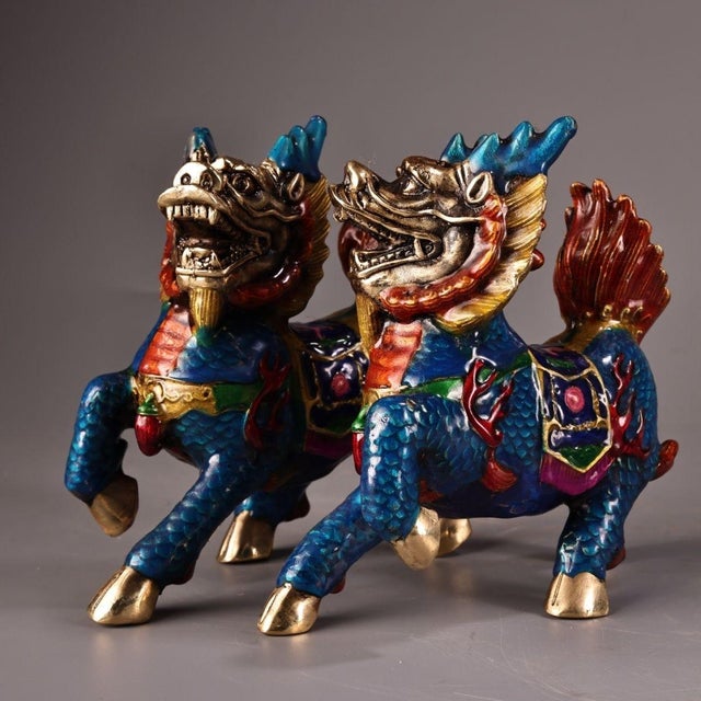 This is a matched pair of vibrant cloisonné enamel Qilin statues, mythical hooved creatures revered in traditional Asian...
