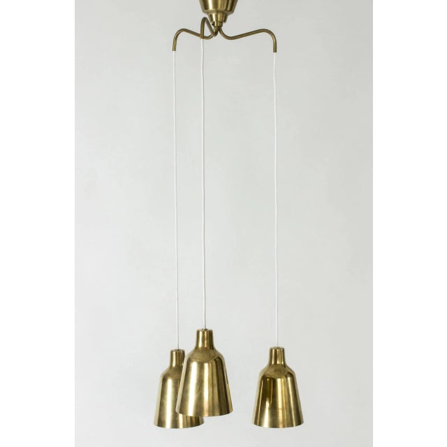 Elegant ceiling lamp by Hans-Agne Jakobsson, with three brass shades. The shades are perforated with small holes that...