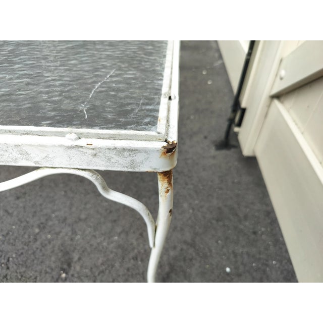 Mid-century Floral patio table. Made out of sturdy wrought iron with a plexi glass top. This table features elegant...