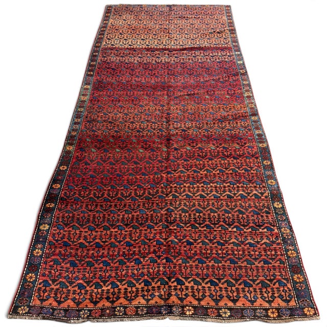 A remarkable antique Kazak runner with an unmistakable personality and a captivating color palette. The rich red field has...