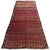A remarkable antique Kazak runner with an unmistakable personality and a captivating color palette. The rich red field has...