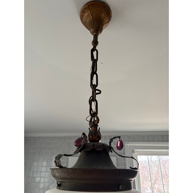 1930s era hardwired pendant light. Original ribbed glass globe affixes to an aged brass socket canopy with matching chain...