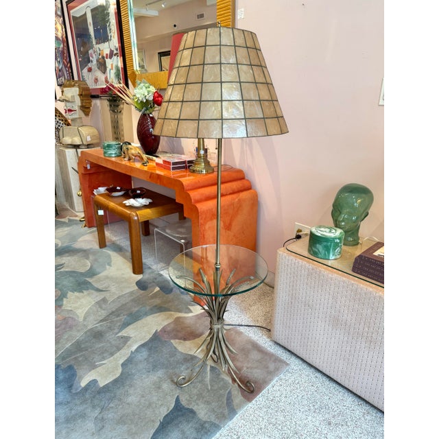 A stunning vintage floor lamp with built in side table. Featuring a metal sheaf of wheat table base, with dark gold toned...