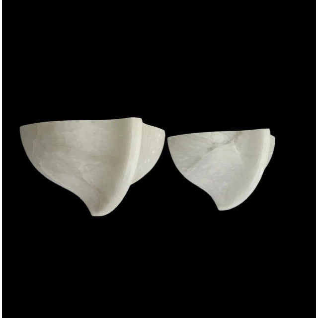 An elegant set of two alabaster wall lamps with a distinctive organic, almost shell-like design. This rare set has a...