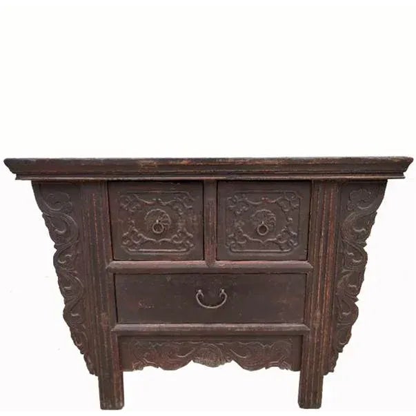 This early 20th century antique Chinese coffer table is adorned by the hand-carved aprons along two sides and the bottom....