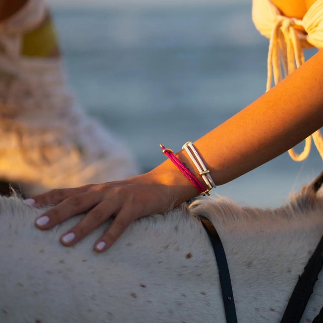 Add a bold pop of color to your style with the Neon Pink Glow Adjustable Gold Rope Bracelet. Designed for those who love...