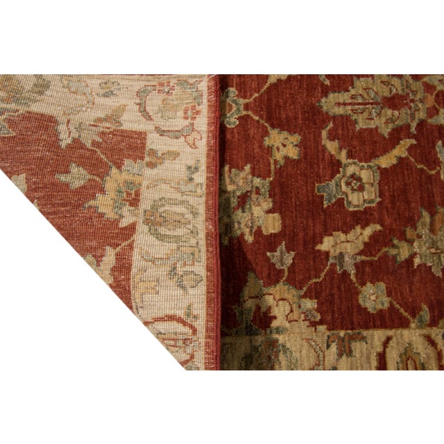 Beautiful contemporary Indian hand-knotted wool rug with a burnt orange field. This piece has tan and beige accents in an...