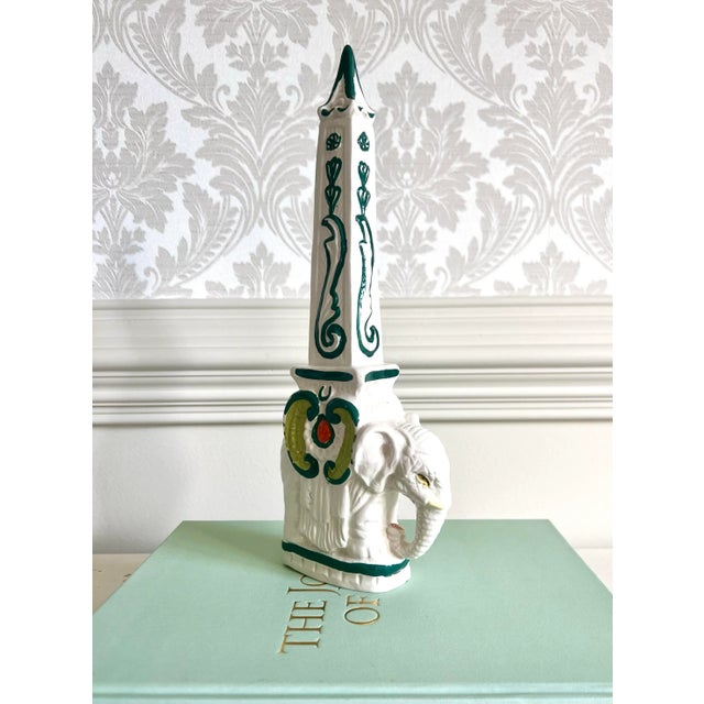 Striking vintage elephant obelisk sculpture, a statement piece that channels both neoclassical grandeur and Hollywood...