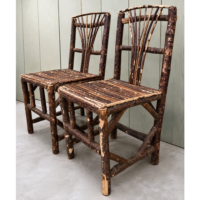 A charming pair of early 20th-century Adirondack-style side chairs handcrafted from natural willow branches and saplings....