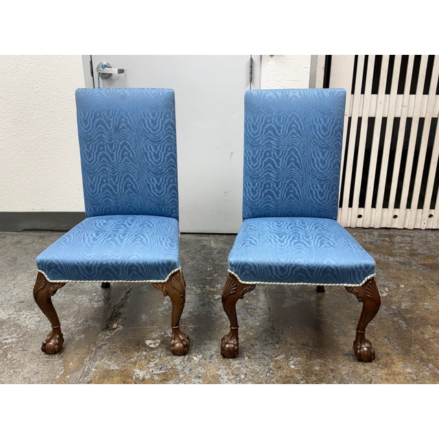 Design Plus Gallery presents a Pair of Vintage Chippendale Side Chairs. The chairs have tall upholstered backs and...
