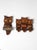 A pair of carved wood owl wall hangings in a classic mid-century folk style, defined by bold carved grain, inset eyes, and...