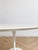 This round dining table is inspired by the iconic Tulip model designed by Eero Saarinen in 1957. Although it doesn't bear...