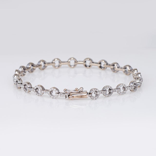 Stylish contemporary round link diamond bracelet crafted in 18 karat white gold. Round brilliant cut diamonds total an...