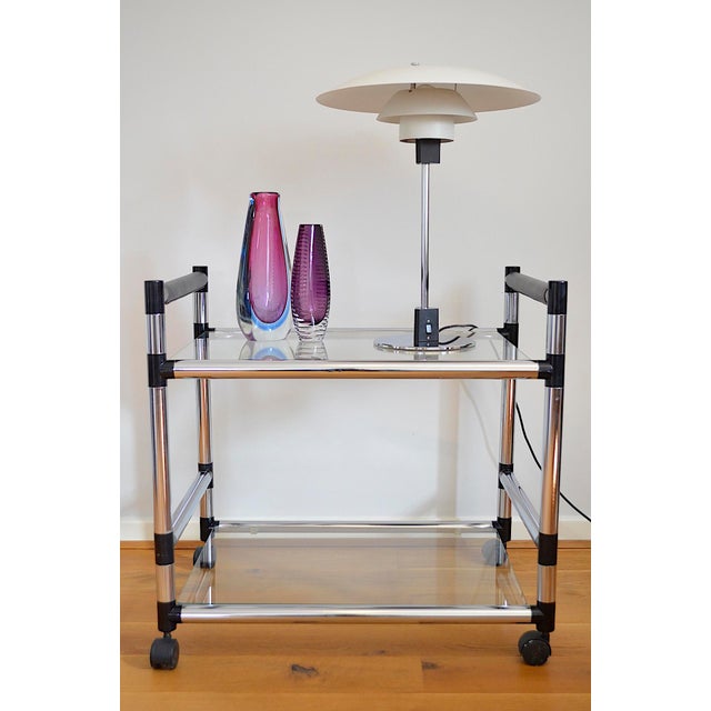 High-quality barware in a postmodern design from the late 1970s/1980s, likely of Italian manufacture. The bar cart is very...
