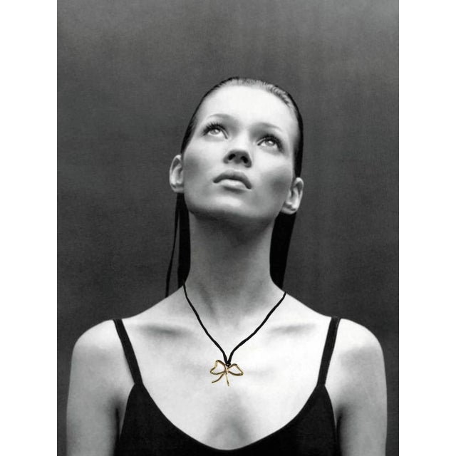 Intricately carved out of wax to mimic the shapes of Bows. This pendant is cast into Brass, polished to a high shine, and...