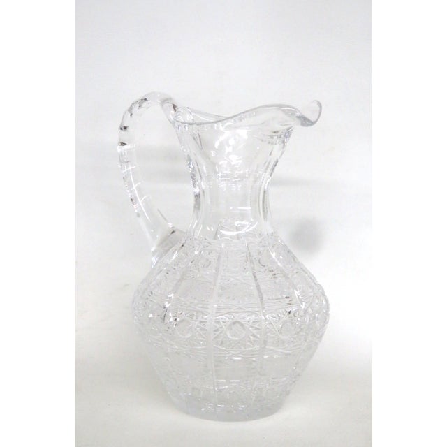 This gorgeous Round Pitcher is made of lead crystal and glass. This stunning ornate pitcher features an elegant handle for...