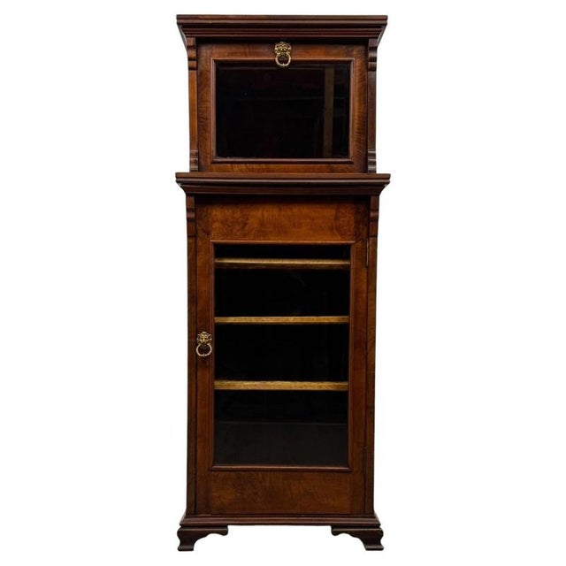 A superb and unusually proportioned 19th-century English display cabinet, finely constructed in walnut and distinguished...