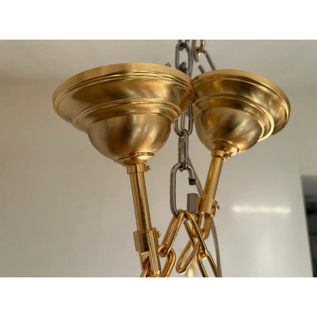 Italian oval hand- made chandelier in a bath of gold 24k metal frame brushed . amber and fumè color of “poliedri” elements...