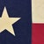 This vintage Texas flag is made from a thin cotton cloth with printed star and sewn panels. Please note staining, minor...