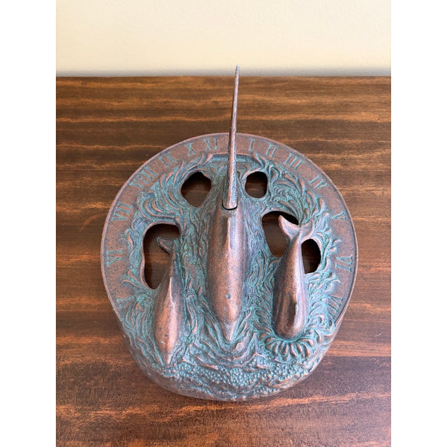 A stunning vintage iron garden sundial featuring three dolphins swimming. This piece would be an ideal accent to your...