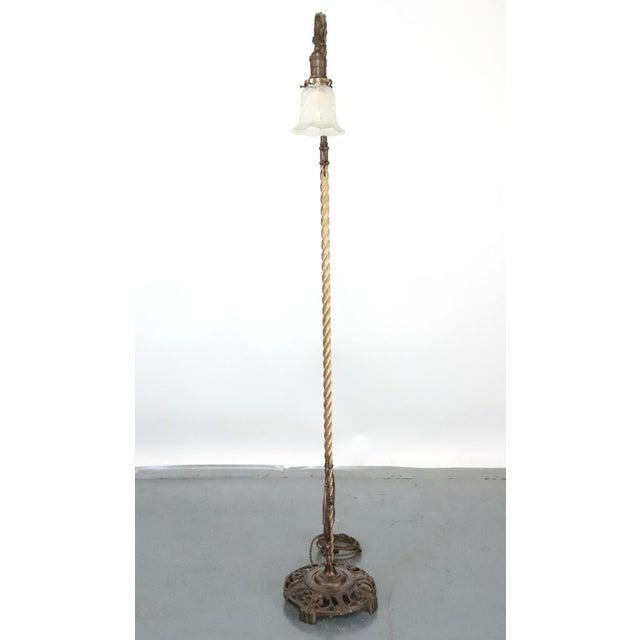 Art Nouveau style cast iron floor lamp with a bridge style arm featuring a ruffled stenciled glass shade. This requires...