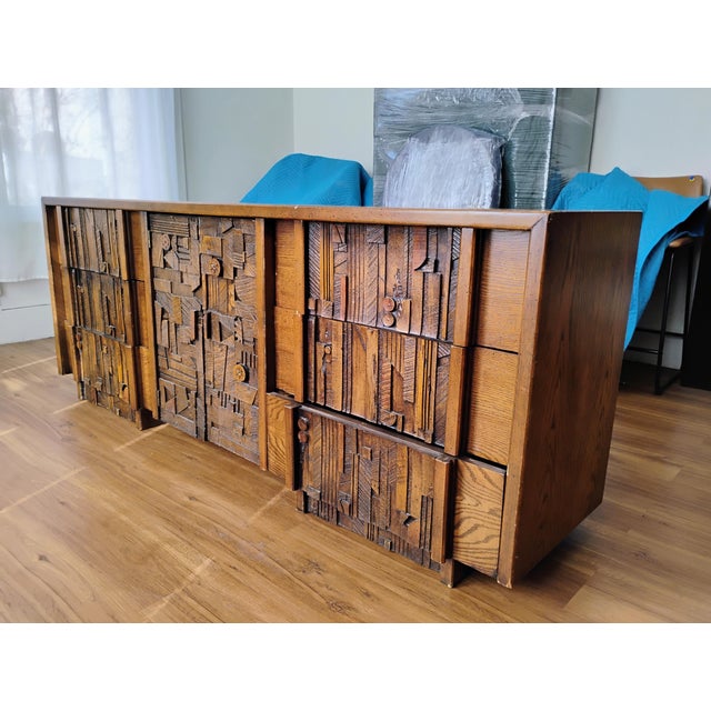 Mid-century modern long dresser by Lane for their "Pueblo" series. Adorned with mosaic style wood collage, making a...