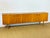 Vintage Scandinavian teak sideboard dating from the 1960s, featuring four storage doors with minimalist shelves and...