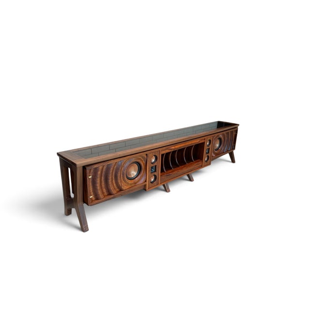 A sculptural walnut integrated stereo console combining exceptional furniture craftsmanship with high-performance Klipsch...