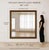 A striking 60-inch antique gold floor mirror featuring an intricately carved ornate frame with a rich aged gilt finish....