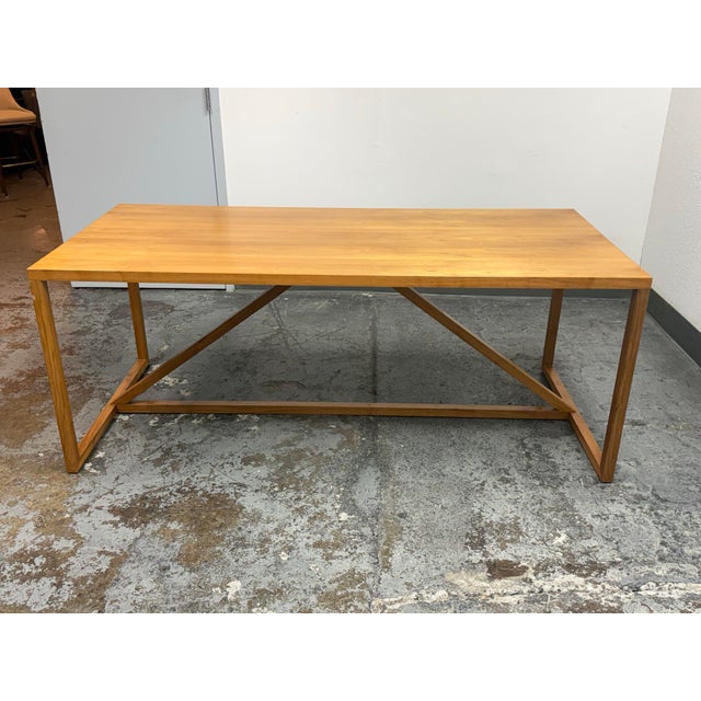 Design Plus Gallery presents the Strut Wood Dining Table in Walnut by Blu Dot. The table pairs a rectangular walnut veneer...