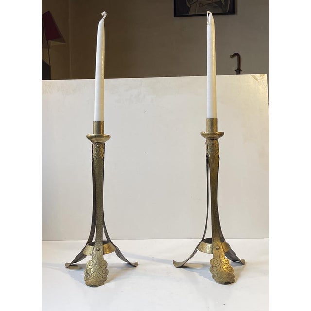 In the style of Richard Riemerschmid and Richard Mueller comes a pair of handmade brass candlesticks. Hammered and...