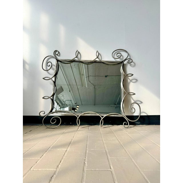 Fabulous vintage postmodern beveled mirror with wonderful wrought iron swirl border. Very hard to find piece, wired to...