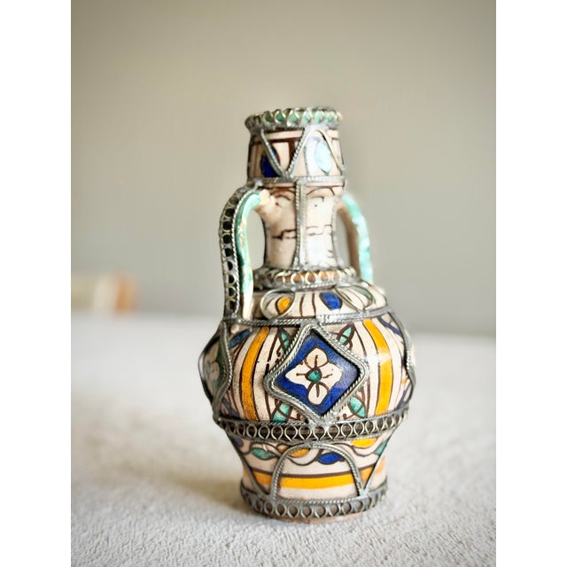 An antique Moroccan ceramic vessel from Fez, dating to the late 19th to early 20th century. This piece reflects the...