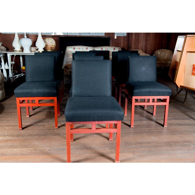 James Mont style set of 12 Moderne red lacquered wood dining chairs with black upholstery. Two arm chairs and ten side...