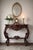 This dramatic vintage console table is a striking example of Victorian Revival / Rococo Revival design, featuring bold...