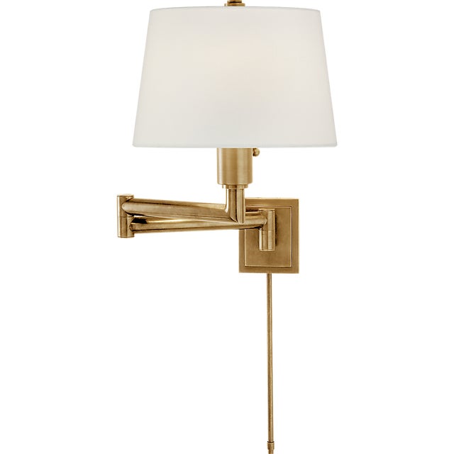 Chunky Swing Arm in Antique-Burnished Brass with Linen Shade Designer: Chapman & Myers Finish: Antique-Burnished Brass...
