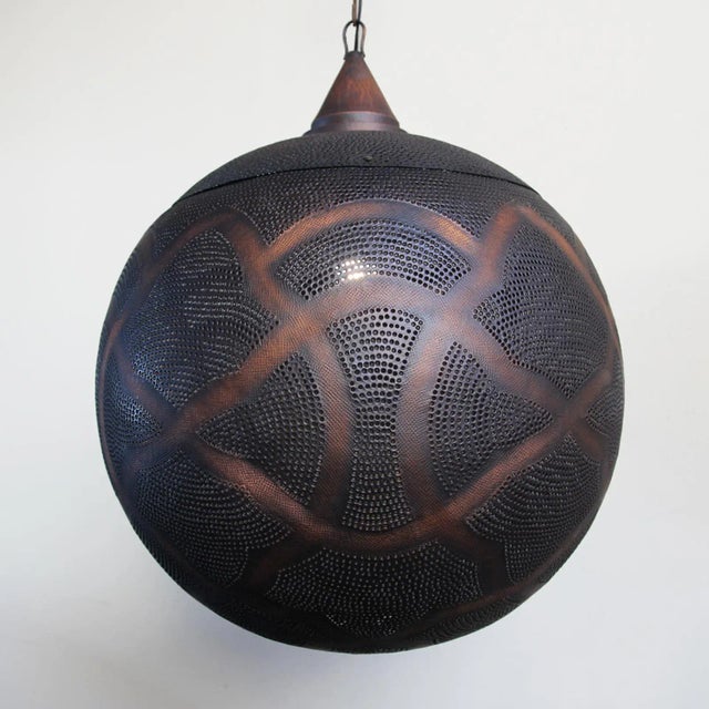 Antiqued copper globe lantern with perforated moorish design patterns that shine beautiful patterns onto walls and...