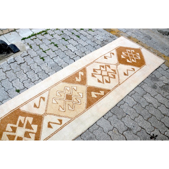 This is a vintage Turkish Oushak rug from the 1960s. The piece was hand-knotted.