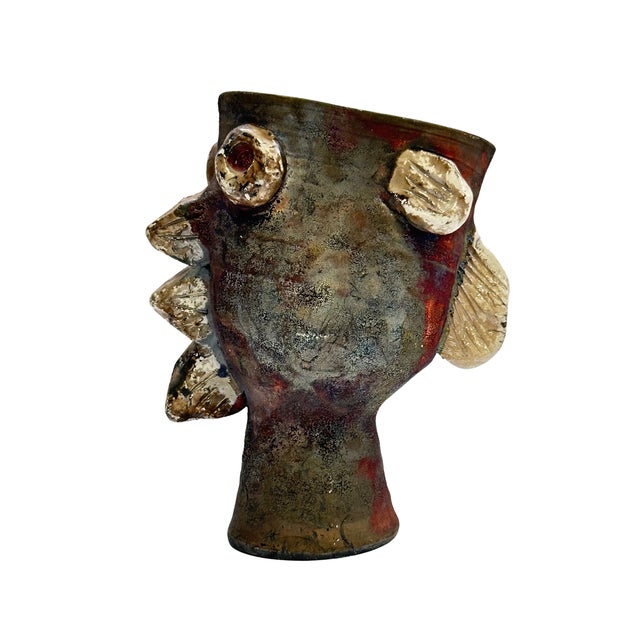 A whimsical vintage studio pottery vase modeled as an abstract fish, featuring a highly sculptural form and richly...