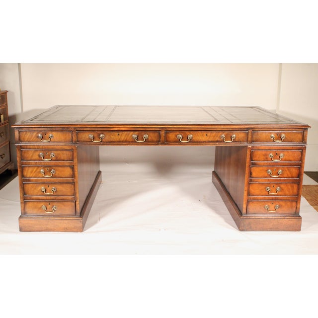 Antique George III style mahogany partners desk with leather top, 19th century. With an inset tooled green leather top,...