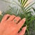 This Trilogy ring features a 0.46 carat round cut natural emerald set in 14k yellow gold. The center stone measures...